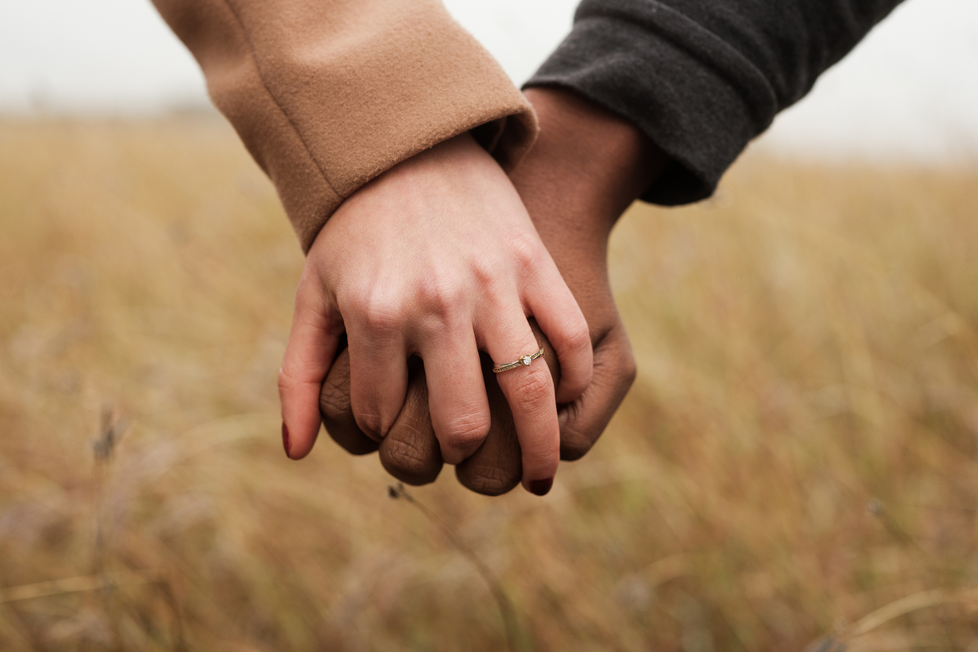 Up close of a couple holding hands in winter coats